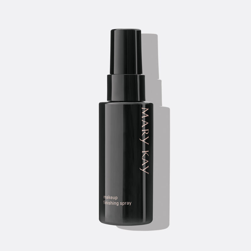 Black Mary Kay Finishing Spray bottle with cap on against plain background