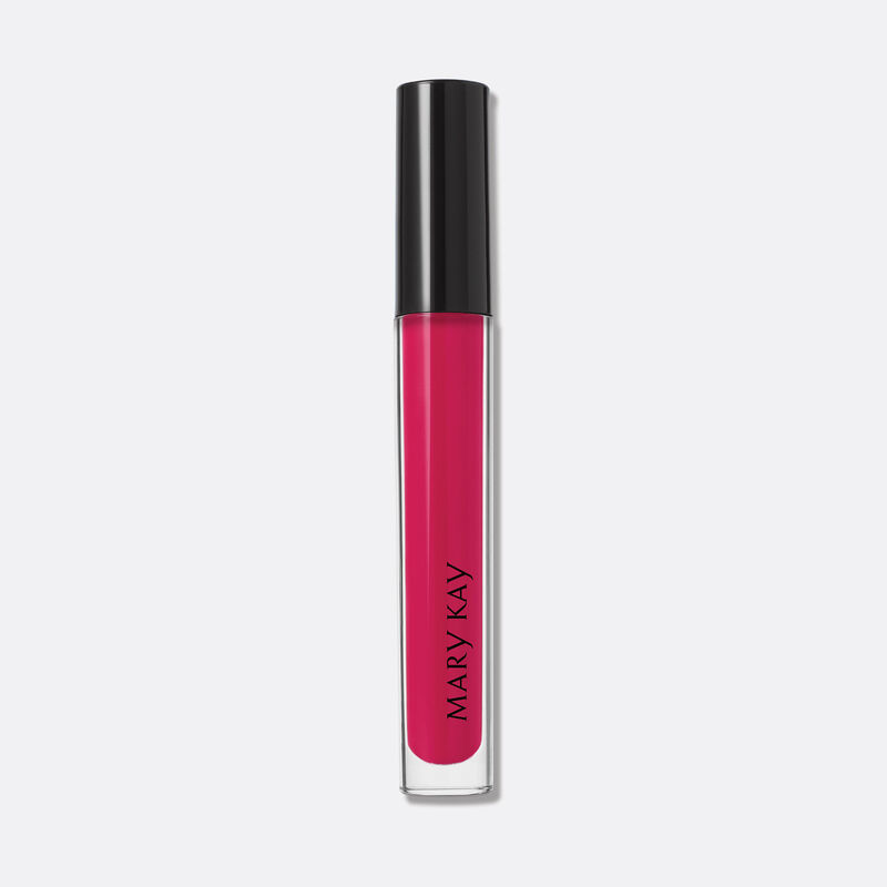 Closed tube of Mary Kay Unlimited Lip Gloss in shade Pink Fusion standing against a grey background.
