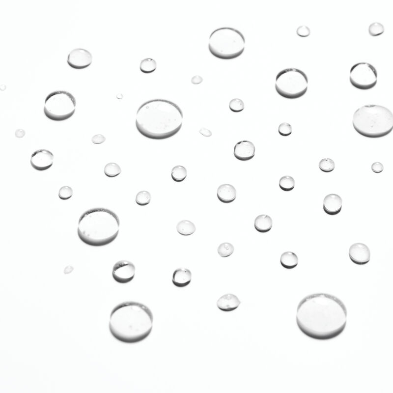 Droplets of Mary Kay Micellar Water on plain background