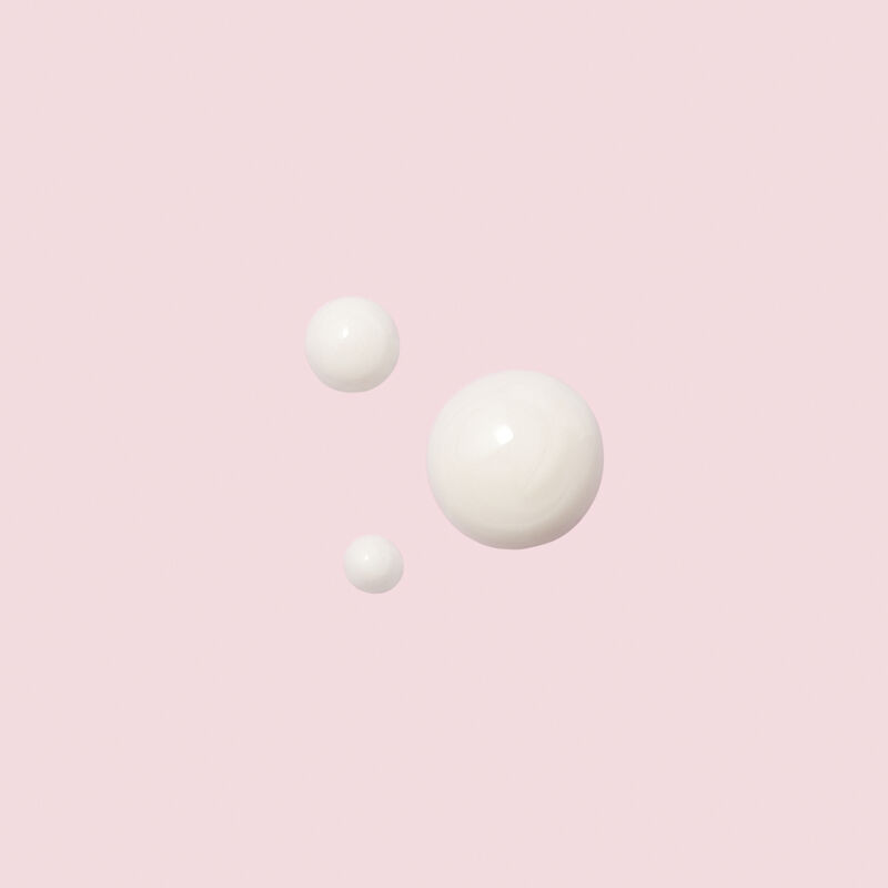 Dots of TimeWise Replenishing Serum C+E on light pink background