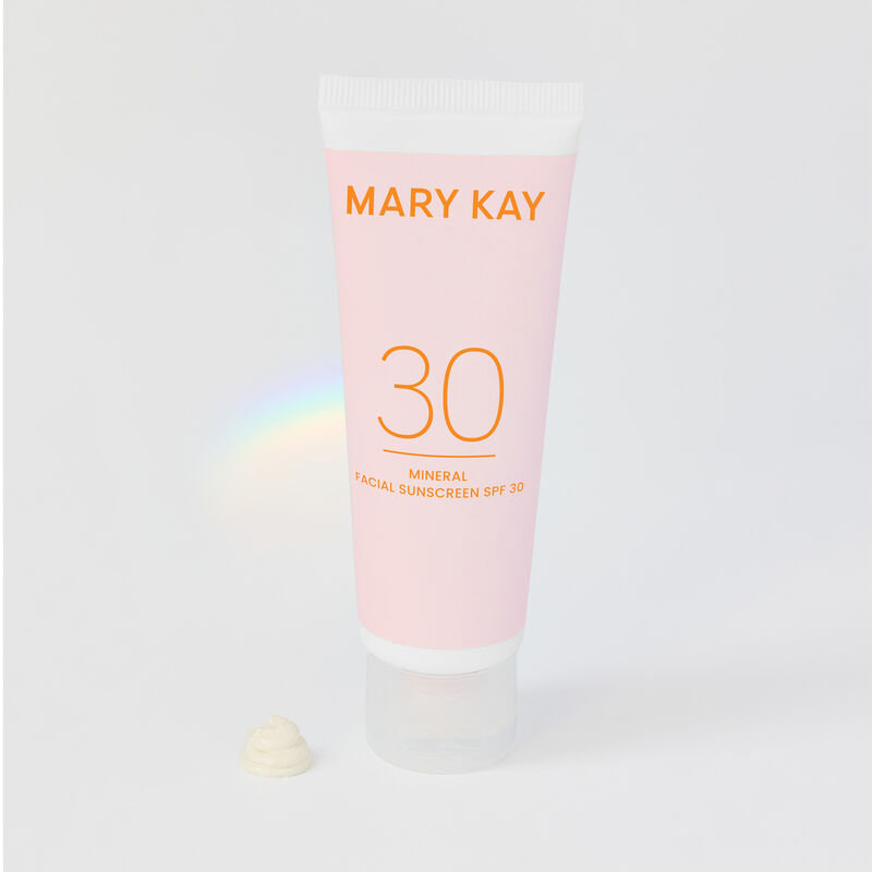 Tube of Mineral Facial Sunscreen SPF 30 with product drip and light refraction rainbow