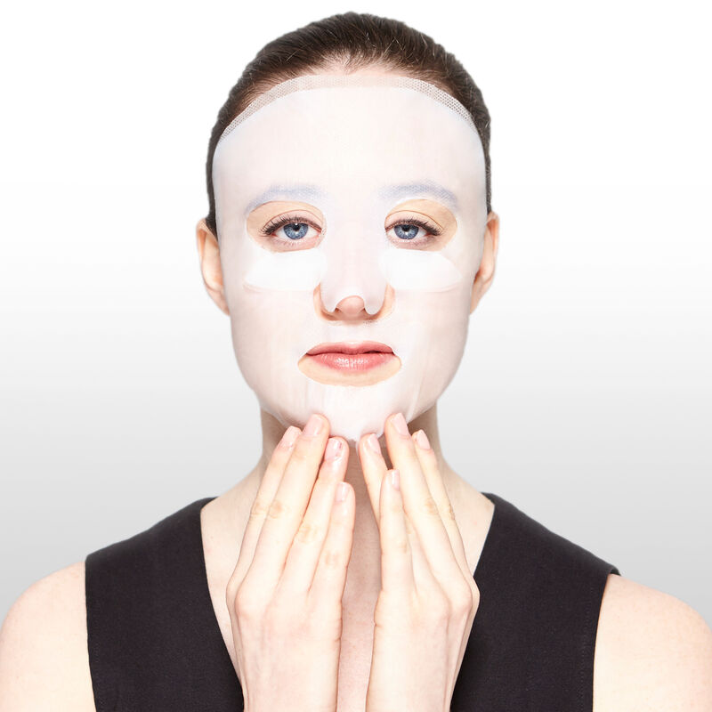 Model applying TimeWise Repair Lifting Bio-Cellulose Mask from Mary Kay.