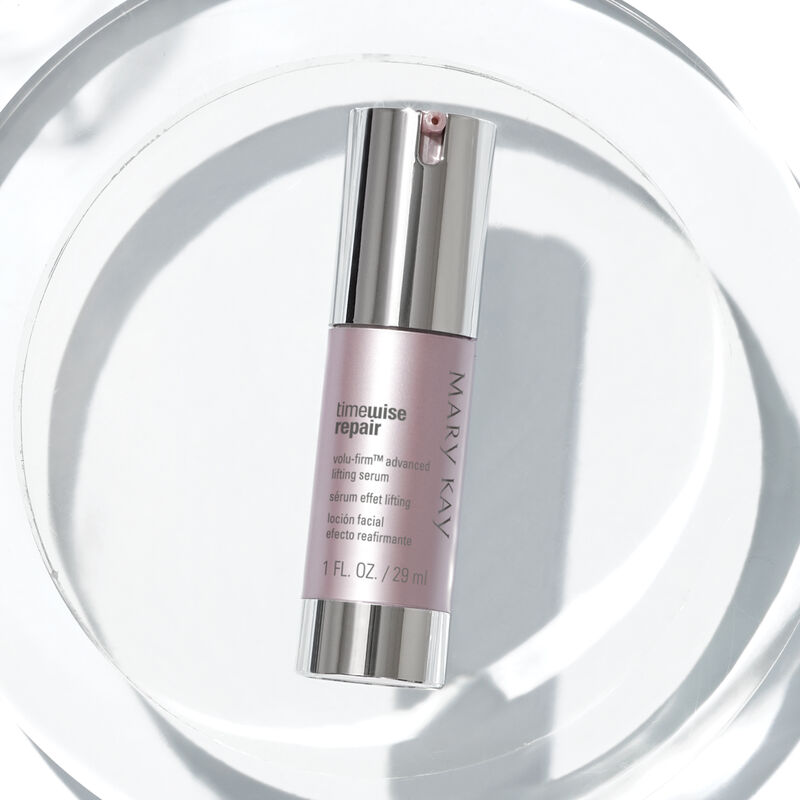 TimeWise Repair Volu-Firm Advanced Lifting Serum staged on a clear acrylic circle