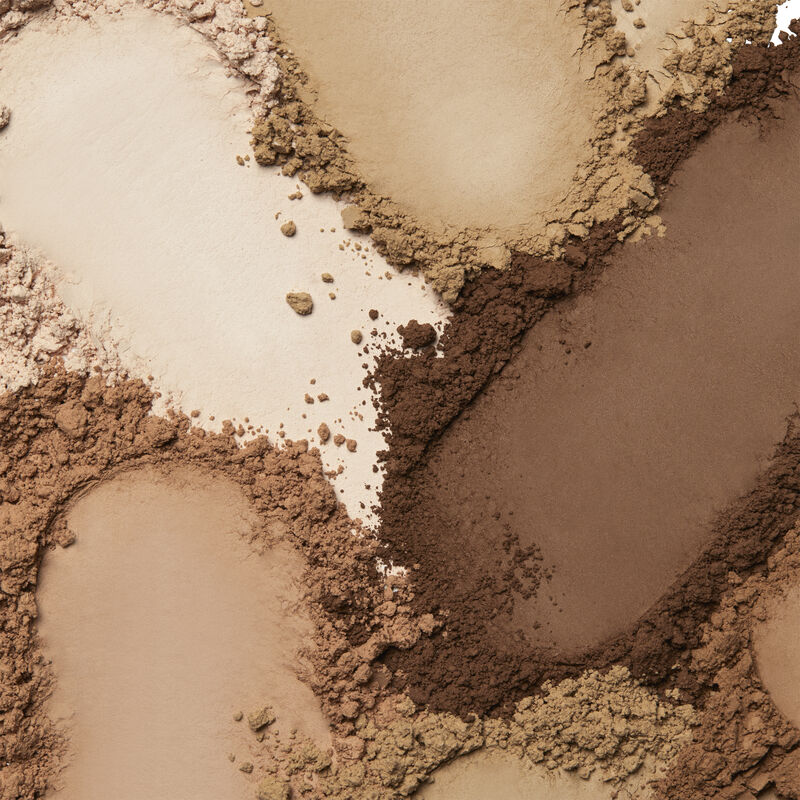 Product rubs of Mary Kay&reg; Silky Setting Powder in shades ranging across ivory, beige and bronze