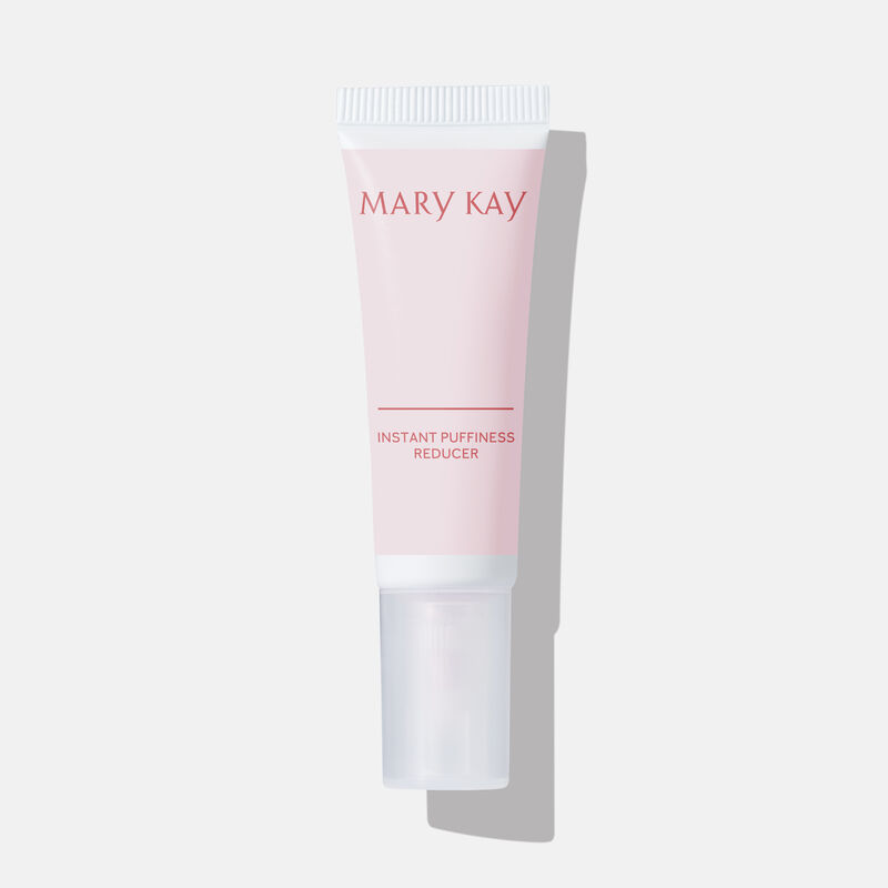 Closed tube of Mary Kay Instant Puffiness Reducer on a grey background.