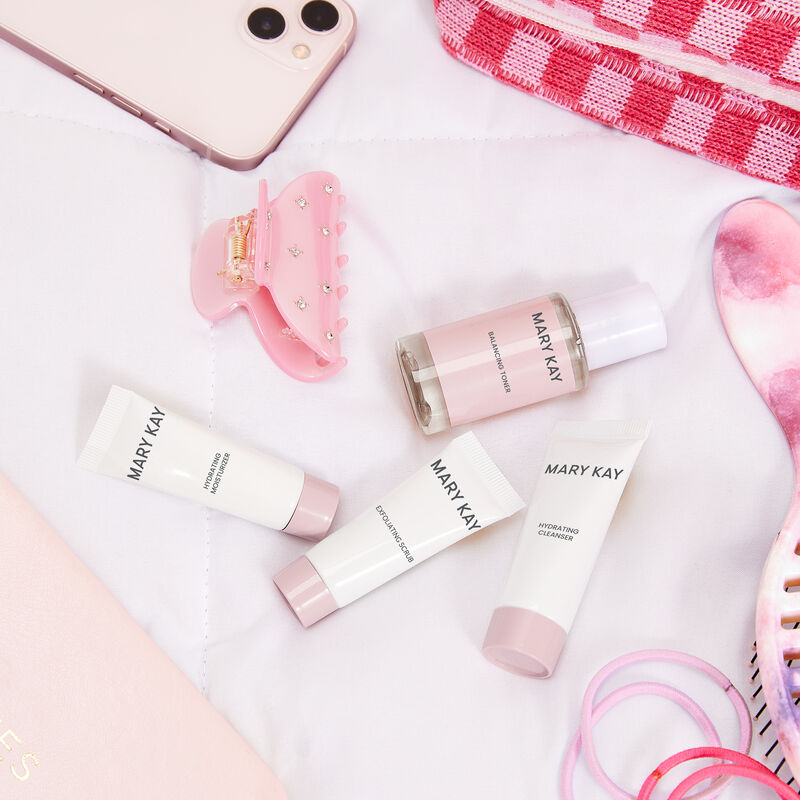 Mary Kay Hydrating Go Set strewn across a counter surrounded by pink beauty accessories