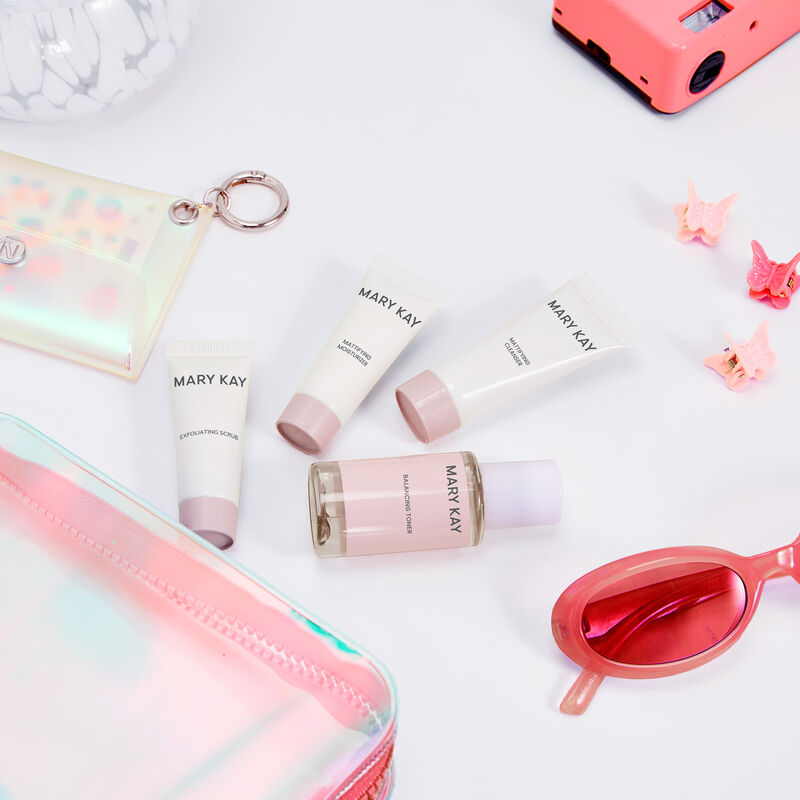 Miniature bottles of Mary Kay Mattifying Regimen on plain background.