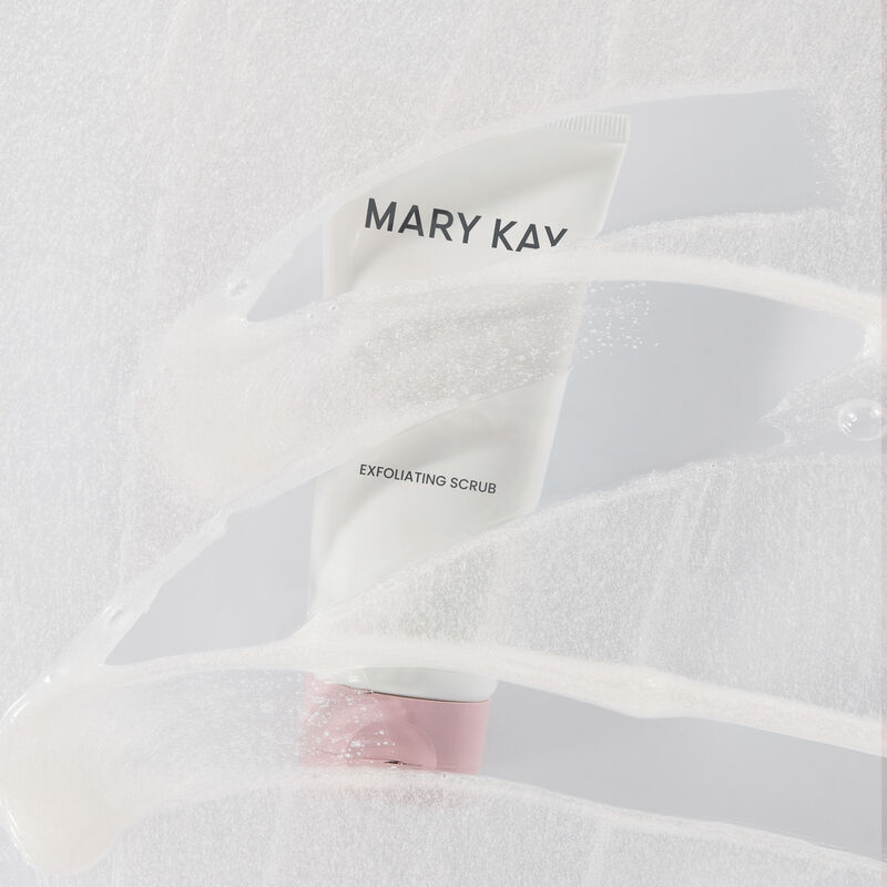 Blurred image of Mary Kay Exfoliating Scrub with product swipe overlay on plain background