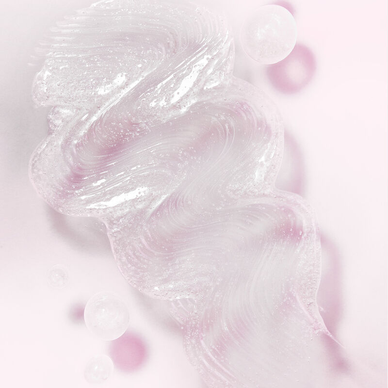 Squeeze of Mary Kay Exfoliating Scrub on light pink background  with shadows