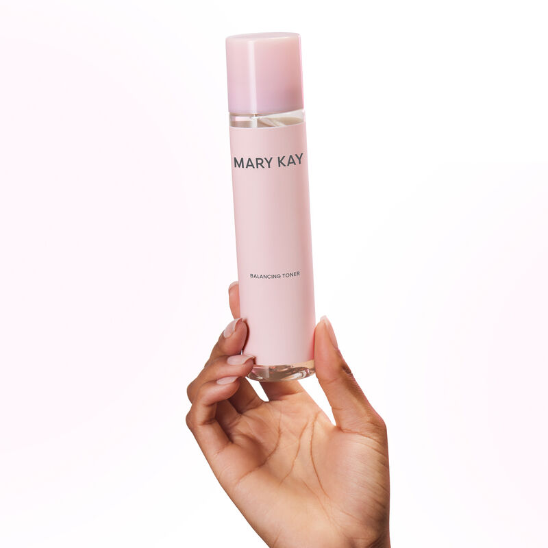 Hand holding bottle of Mary Kay Balancing Toner