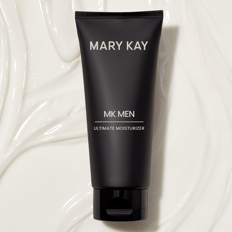 Tube of MKMen Ultimate Moisturizer lying on a background of the moisturizer, displaying the smooth texture