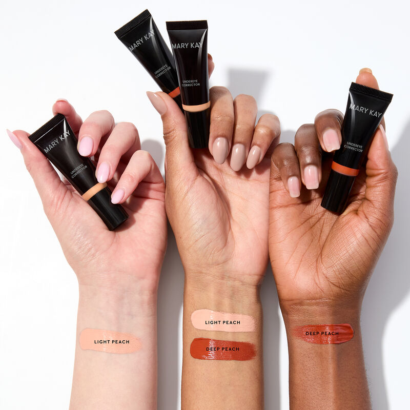 Swipes of Light Peach and Deep Peach Mary Kay Undereye Corrector are seen on wrists on light, medium and deep skin tones.