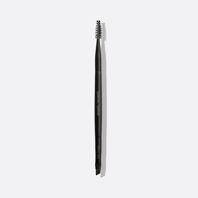 Mary Kay Eyebrow/Eyeliner Brush, a dual-sided brush with angled brush on one side and spoolie on the other, on plain background