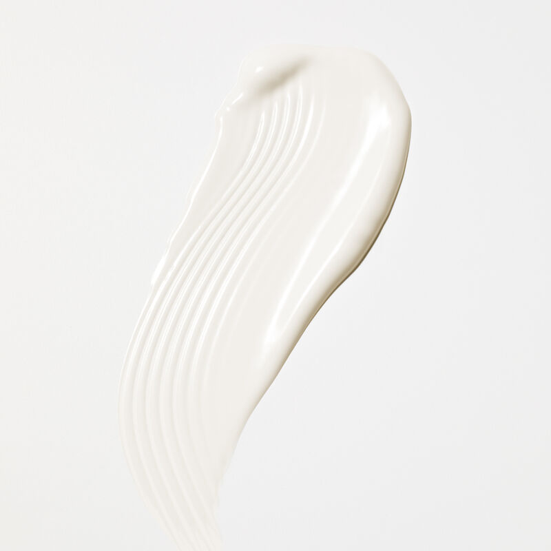 White swipe product rub of Mary Kay&reg; Sunscreen SPF 50  on plain background