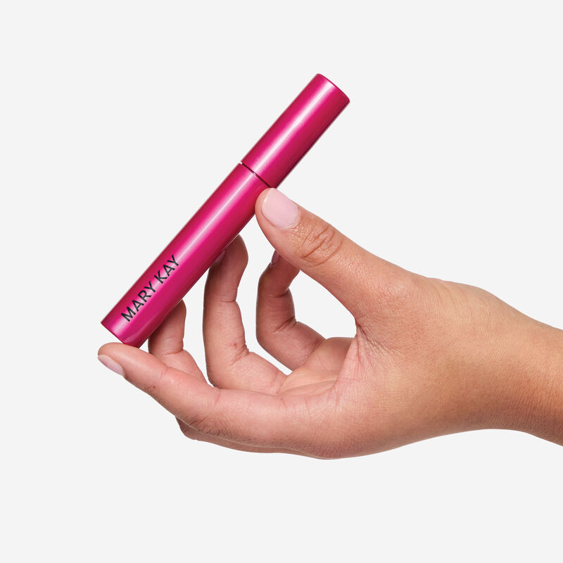 Hand holding Lash Love Fanorama Define+Lift Mascara set against a white background