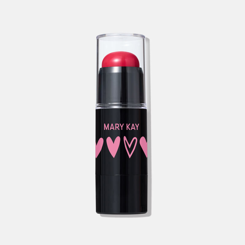 Special-edition Mary Kay Blush Stick in shade Spark Change, a hot pink cream blush in a sleek black tube with pink heart designs and a clear cap.