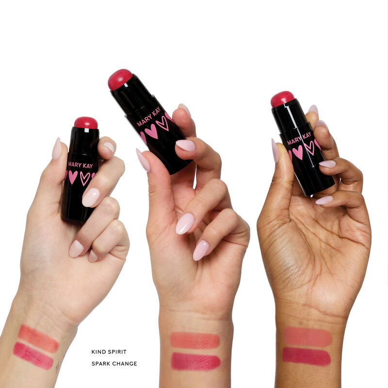 Three hands holding special-edition Mary Kay Blush Stick in shades Kind Spirit and Spark Change, showing both shades on different skin tones.