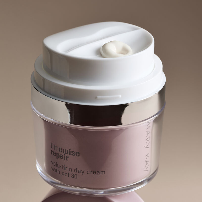 Close-up shot of Day Cream against a beige background.