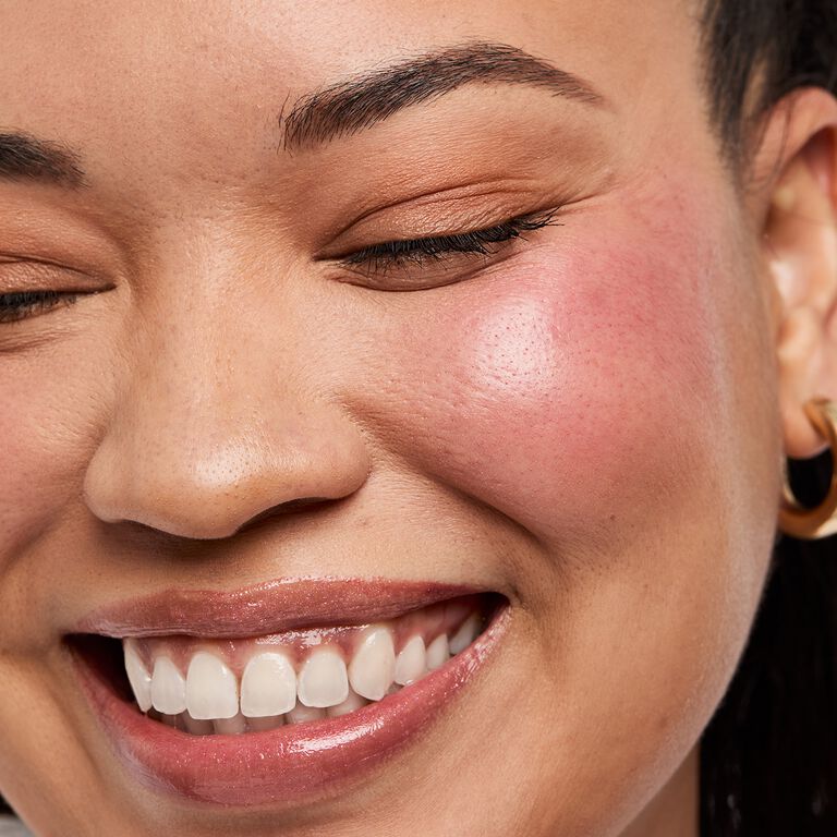 Close-up of model with blush smiling