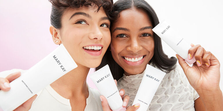 Two brunette models holding products of the Mary Kay Skin Care regimen and smiling