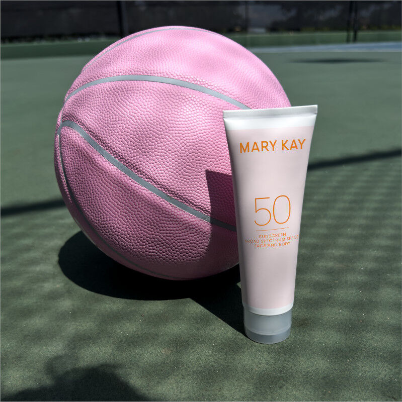 Tube of Mary Kay Sunscreen Broad Spectrum SPF 50 in front of pink basketball on a sports court