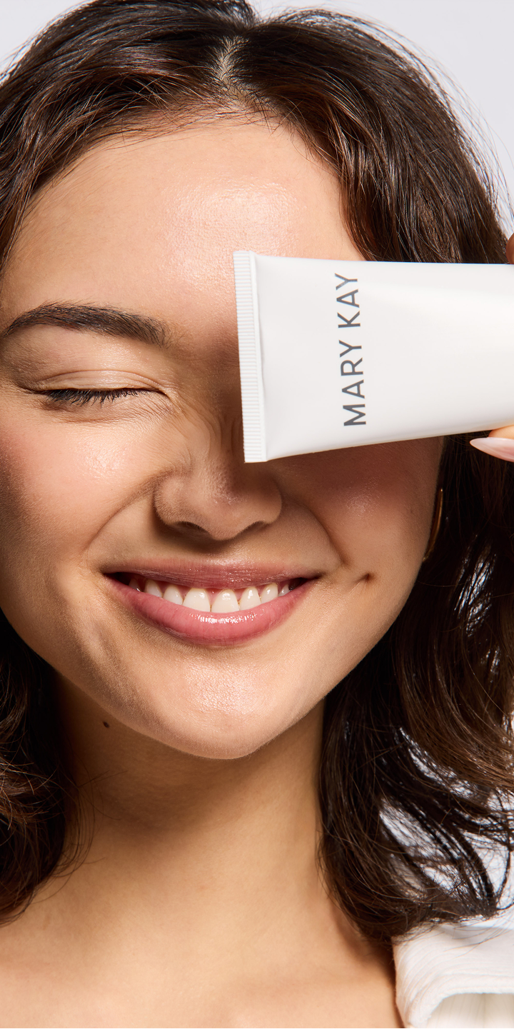 A close up of a woman with cleanser.